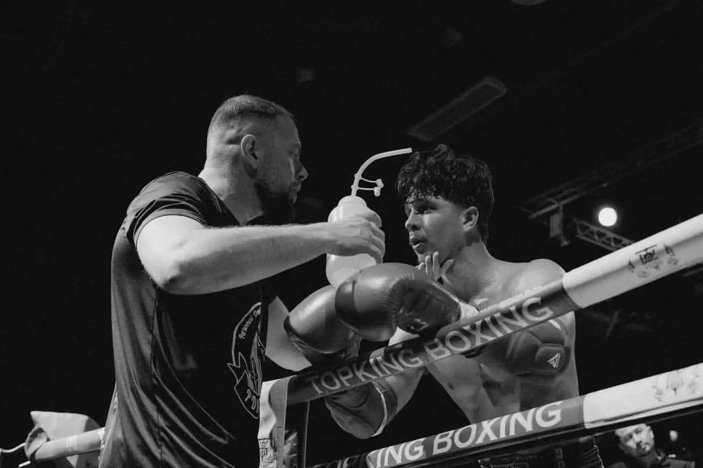 Callum coaching a fighter one-on-one in the corner on fight night